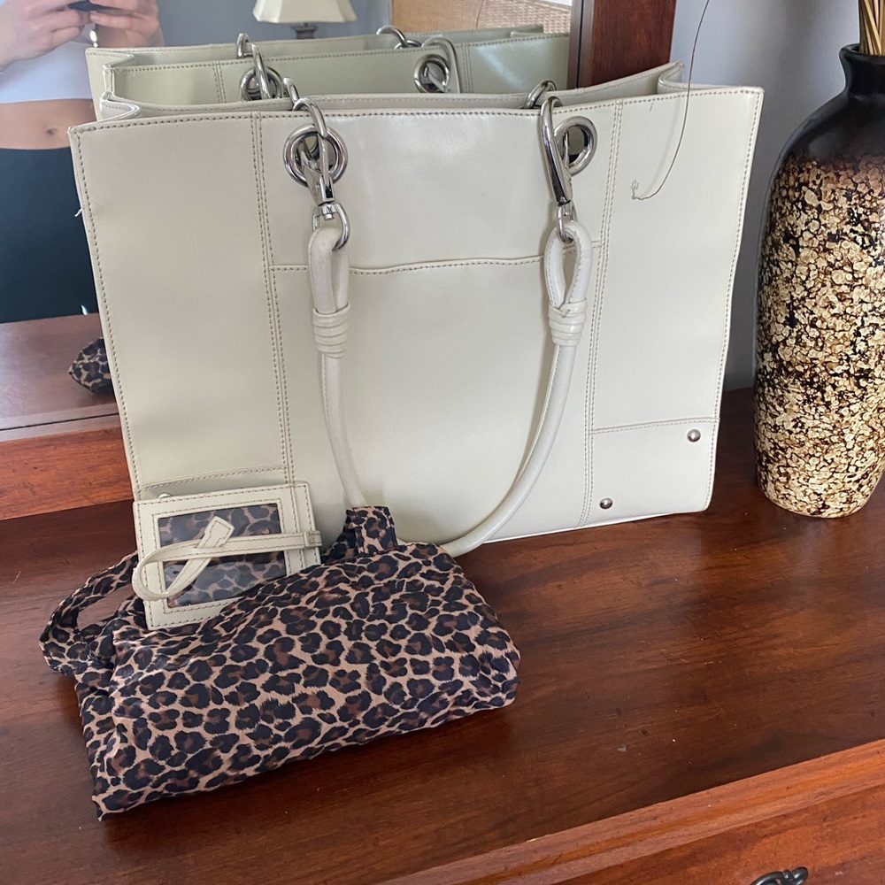REAL Leather!! Quality and style tote. Look the part without the price tag :)
